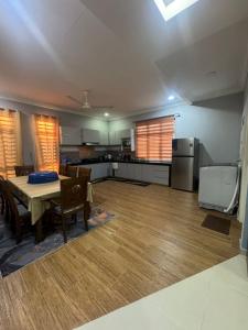 a living room with a table and a kitchen at SYA Homestay Bachok in Bachok