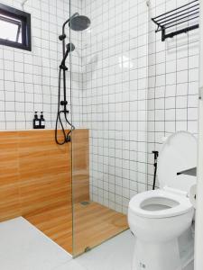 a bathroom with a toilet and a glass shower stall at ลิบเบล โฮมสเตย์ in Ban Nong Sa +10 photos