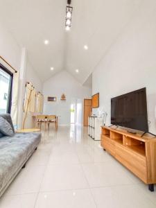 a large living room with a large flat screen tv at ลิบเบล โฮมสเตย์ in Ban Nong Sa