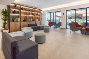a lobby with couches and chairs in a building at Hotel Vibra Vila -3SUP- New Opening 2026 in Ibiza Town
