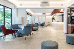 a waiting area in a hospital with chairs and tables at Hotel Vibra Vila -3SUP- New Opening 2026 in Ibiza Town