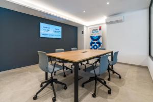 a conference room with a wooden table and chairs at Hotel Vibra Vila -3SUP- New Opening 2026 in Ibiza Town +39 photos