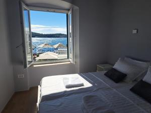 a bedroom with a large bed with a large window at La Vie Seaside Residences in Šibenik