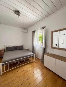 a bedroom with a bed and a window in it at Stone & Sea Retreat in Órmos Marathokámpou