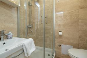 a bathroom with a shower and a sink and a toilet at Apartment and Rooms Stay in Dubrovnik +24 photos