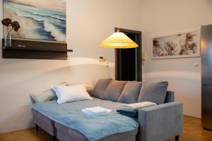 a couch in a living room with a lamp at Apartma Drapšinova - Celje in Celje