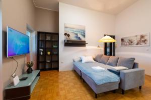 a living room with a couch and a flat screen tv at Apartma Drapšinova - Celje in Celje