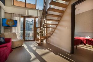 a living room with a spiral staircase in a house at Apartamenty Nautilus in Świnoujście