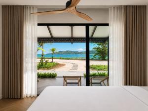 a bedroom with a bed and a view of the beach at Wave & Vibes Koh chang in Ban Chek Bae (1) +23 photos
