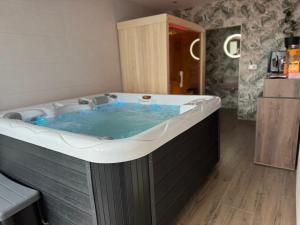 a large hot tub in a room with at Apartments & Spa - Insula Vita in Bihać +39 photos