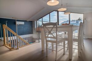 a dining room with a white table and a chair at Apartamenty Nautilus in Świnoujście