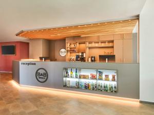 a store with a display of bottles of alcohol at B&B HOTEL Rüsselsheim in Rüsselsheim