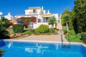 a large house with a swimming pool in front of it at Villa Vista in Valados