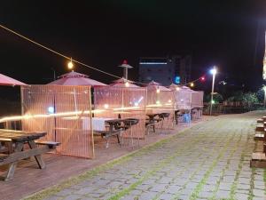 a row of tables and umbrellas at night at Nuhrang Nahrang in Taean