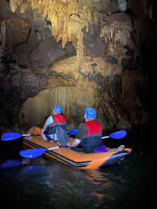 two people in a kayak in a cave at Phong Nha Midtown Hotel in Phong Nha