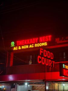 a sign for a food court with red lights at Thekkady Nest Residency in Thekkady +3 photos