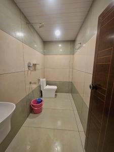 a small bathroom with a toilet and a sink at Thekkady Nest Residency in Thekkady