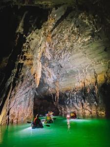a group of people in kayaks in a cave at Phong Nha Midtown Hotel in Phong Nha