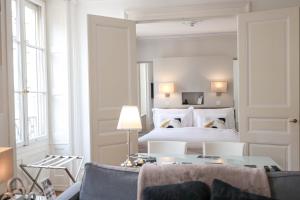 a bedroom with a bed and a table and chairs at Swiss Luxury Apartments Geneva - Serviced Apartments in Geneva +86 photos