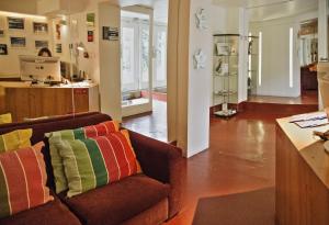 a living room filled with furniture and a kitchen at Porto Spot Hostel in Porto