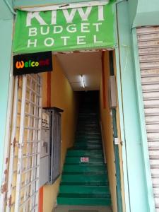 a staircase leading to a building with a green awning at kiwi budget hotel in Rawang