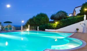 a swimming pool in a villa at night at Residence Chiesiola in Vieste