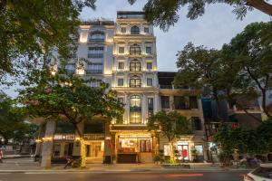 a tall white building on a city street at Binh Anh Hotel in Hanoi