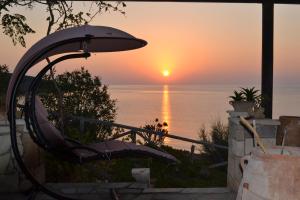 a view of the sunset from a hot tub at Athena Rooms in Kato Zakros