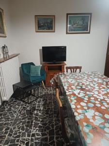 a bedroom with a bed and a flat screen tv at A casa di Nonna in Gambassi Terme