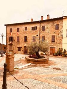 a large brick building with a tree in front of it at A casa di Nonna in Gambassi Terme