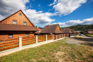 a wooden fence in front of a house at Drevenica Horehronka in Závadka nad Hronom