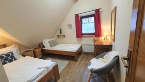 a small room with a bed and a desk at Chalupy Bret v Krkonoších- prostorná chalupa se 3 apartmány, se saunou nebo vířivkou in Žacléř
