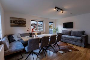 a living room with a table and a couch at Alpen Lodge Kirchberg in Kirchberg in Tirol