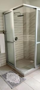 a shower with a glass door in a bathroom at Blue Water Resort in Diani Beach +17 photos