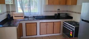 a kitchen with a sink and a stove top oven at Blue Water Resort in Diani Beach