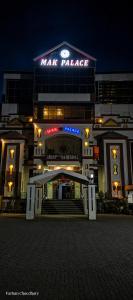 a large building with a star palace sign on it at Mak Palace Hotel in Sialkot