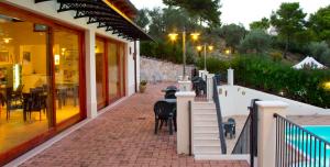 a restaurant with tables and chairs on a brick sidewalk at Residence Chiesiola in Vieste