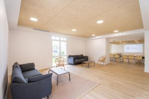a waiting room with couches and chairs and a table at Le Logis du Manoir in Sarzeau +29 photos