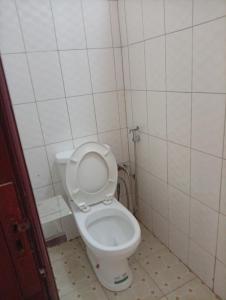 a bathroom with a white toilet in a room at Spring homes2 in Jinja +20 photos