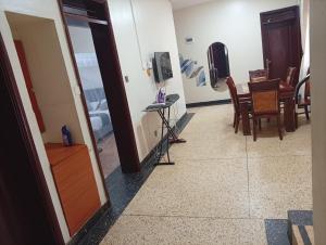 a hallway with a room with a table and chairs at Spring homes2 in Jinja
