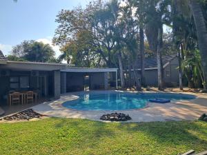 a swimming pool in the backyard of a house at Casa Kruger Lodge in Phalaborwa