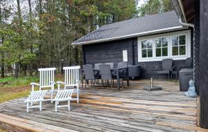 a deck with chairs and a table on a house at Awesome Home In Hurup Thy With Wifi in Sønder Ydby +13 photos
