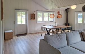 a living room with a couch and a table at Awesome Home In Hurup Thy With Wifi in Sønder Ydby