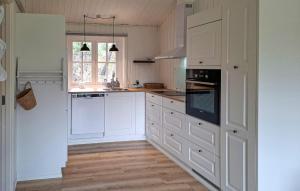 a white kitchen with white cabinets and a window at Awesome Home In Hurup Thy With Wifi in Sønder Ydby