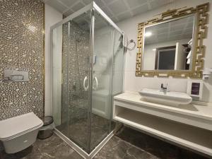 a bathroom with a shower and a sink and a toilet at Vera Vista Hotel in Ipekyolu +35 photos