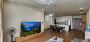 a living room with a large painting on the wall at Skylake Phạm Hùng in Hanoi