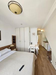 a bedroom with a bed and a table with chairs at Apartmani PROVA in Sveti Stefan