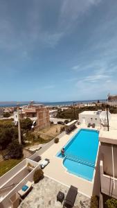 a swimming pool on the side of a building at Aestas Apartments in Agia Marina Nea Kydonias