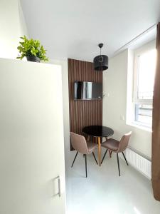 a small dining room with a table and chairs at ЖК АЯ Студія 1 плюс 1 in Kropyvnytskyi +6 photos