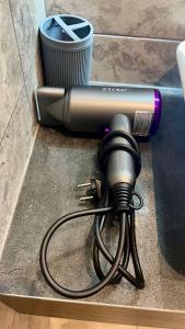 a hair dryer sitting on a floor next to a trash can at ЖК АЯ Студія 1 плюс 1 in Kropyvnytskyi